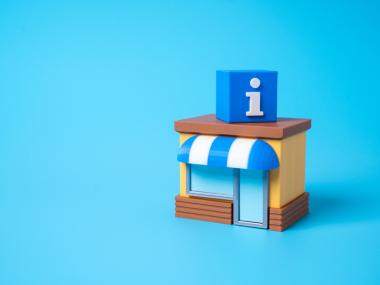 Illustration af en lille bygning med blå og hvid markise, store vinduer og en blå kube med et hvidt informationssymbol (bogstavet "i") ovenpå taget. Bygningen står på en ensfarvet lyseblå baggrund og repræsenterer et informationscenter.